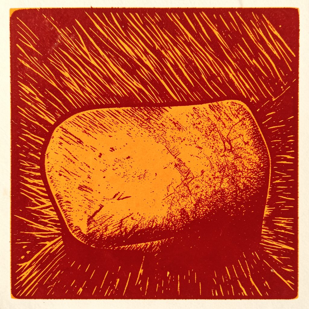Carved linocut relief print of a driving helmet in olive-gold